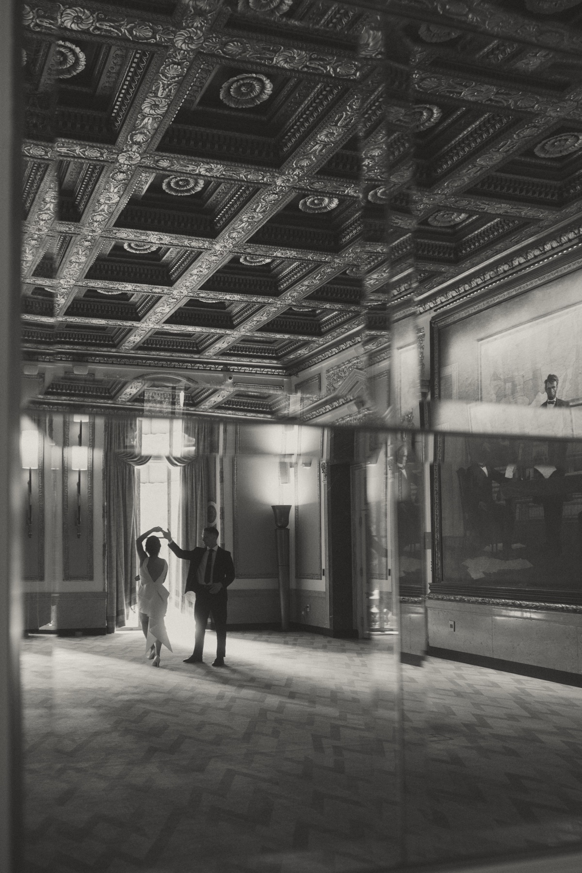 Mark and Vivian dancing in an ornate hotel room