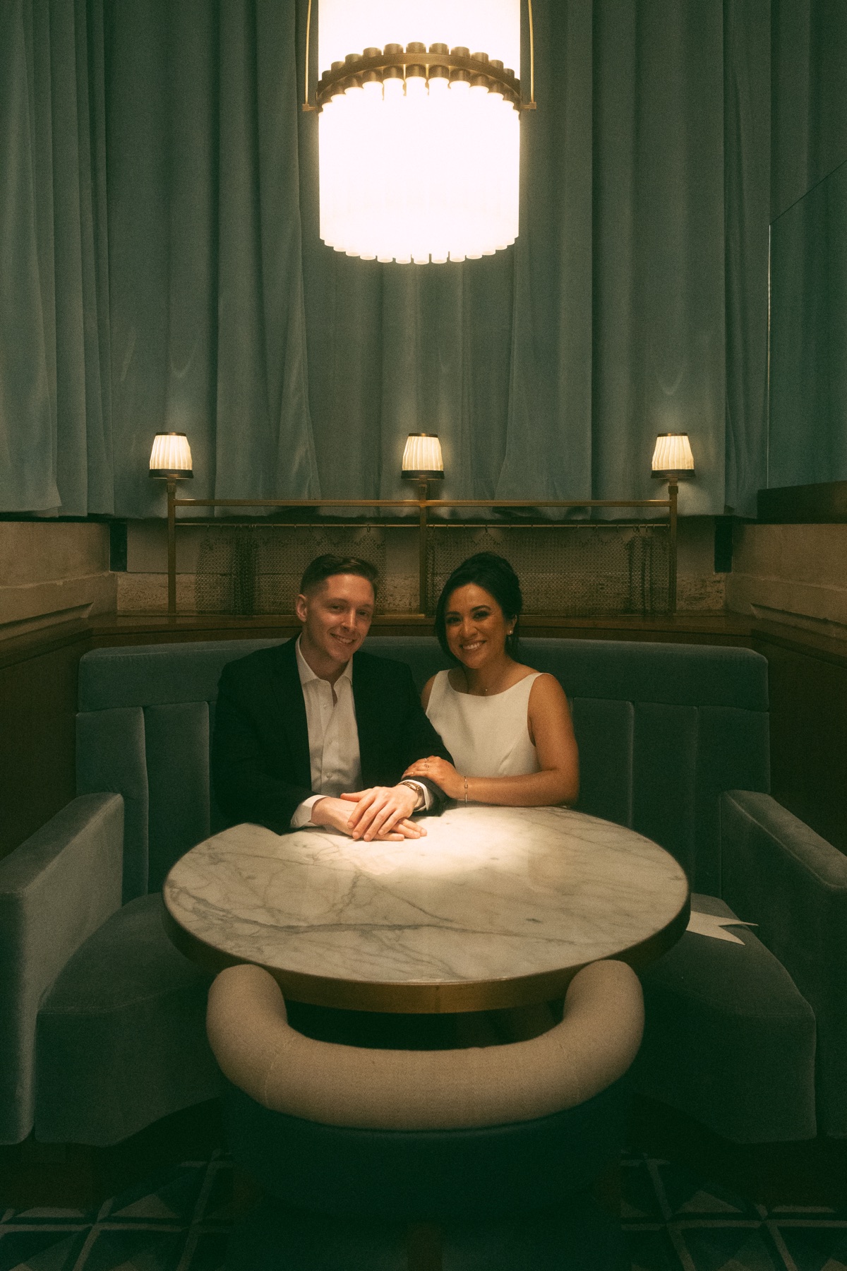 Mark and Vivian seated together in a dim lounge